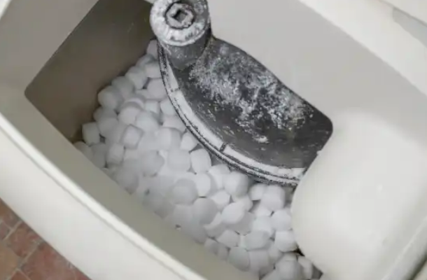 Close-up of salt pellets in a water softener