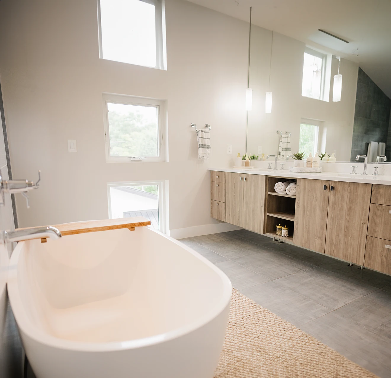 a modern bathroom with floor to ceiling windows.