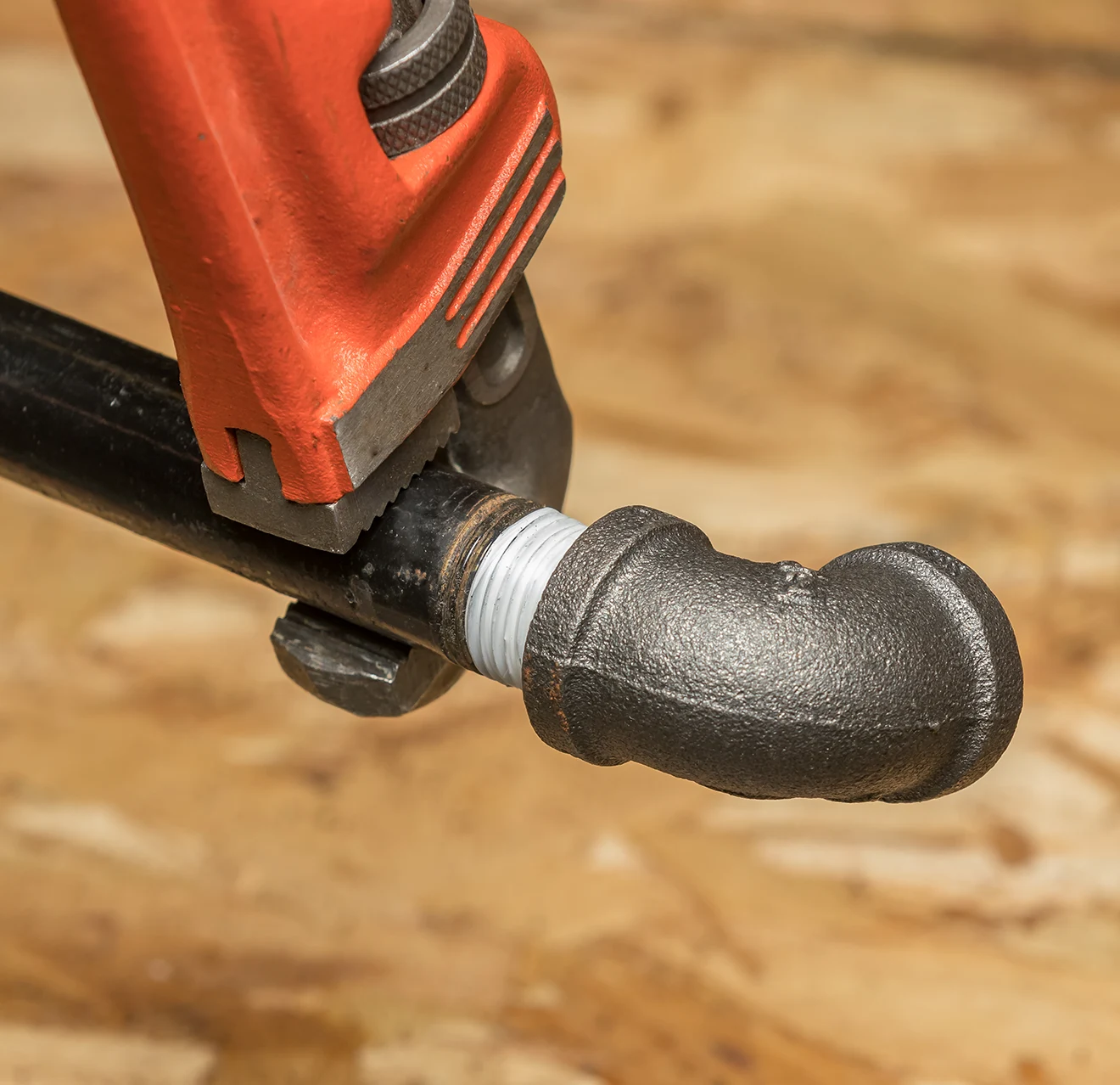 image of a wrench on a pipe.