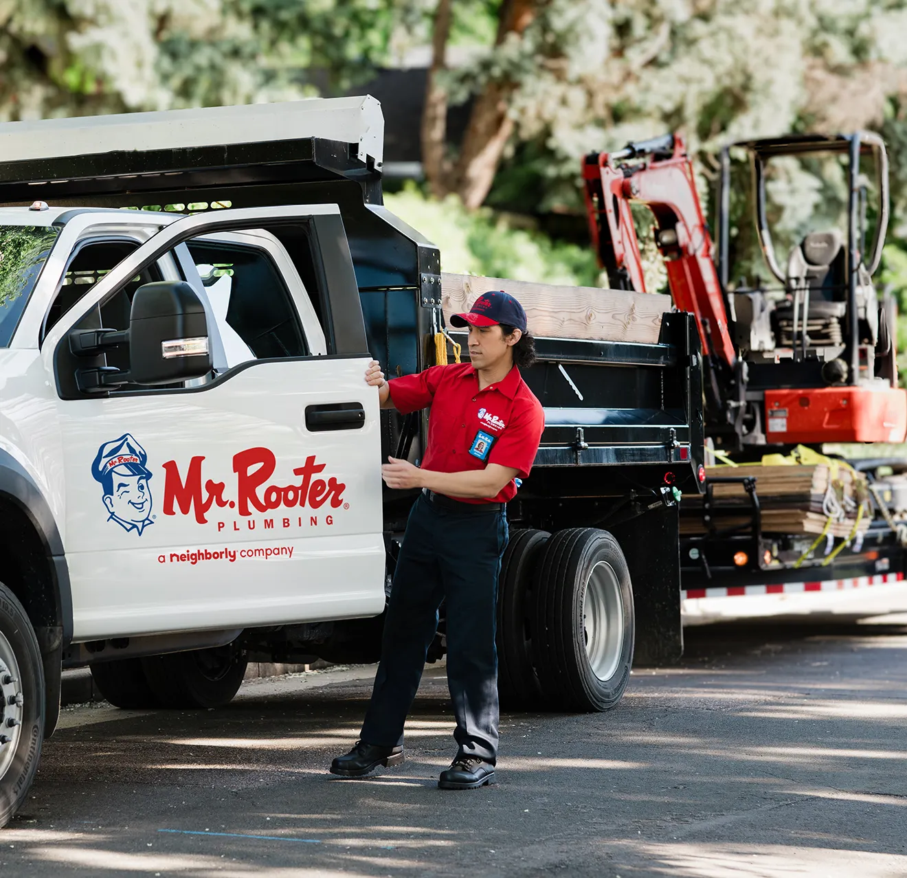 Mr. Rooter technician shutting the front door of his work truck.