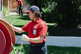 Mr. Rooter professional preparing to clean a sewer.