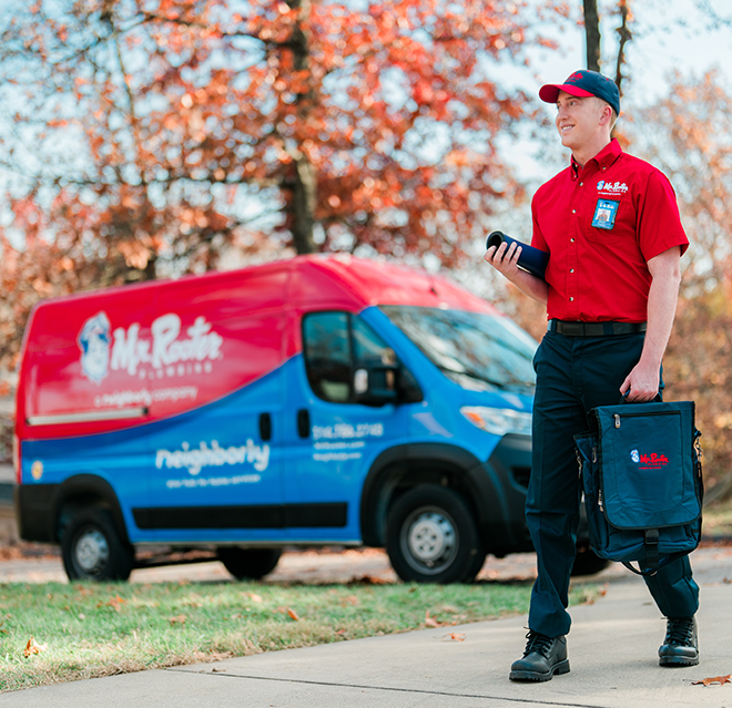 Mr. Rooter Plumbing professional walking up to a customer's home.