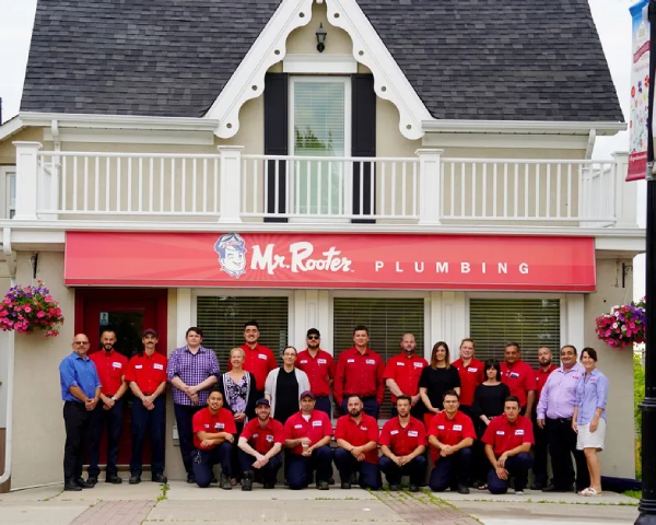 Mr. Rooter Plumbing of Mississauga team posing in front of a company building in Mississauga, ON