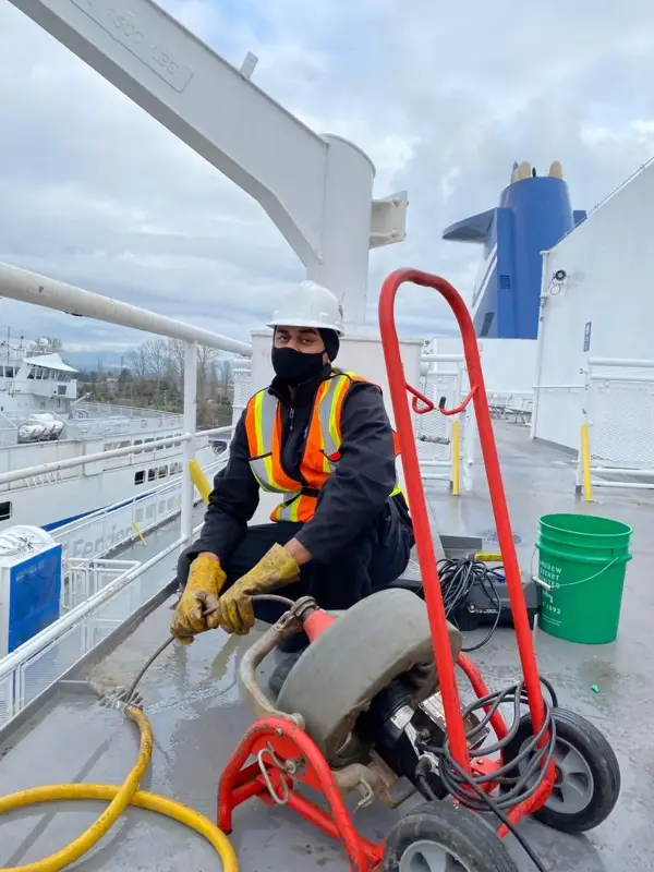 Mr. Rooter Plumbing professional clearing clogged drain on a boat in Vancouver.