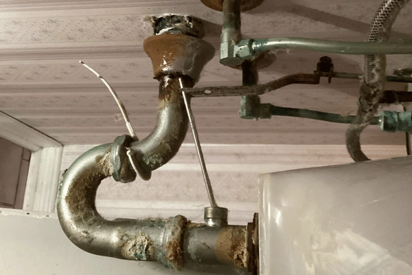 Before image of repiping a sink for a bathroom faucet installation.
