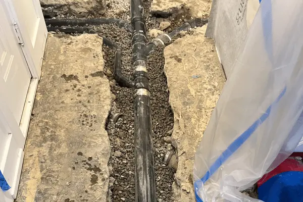 aligning the pipes and grading the foundation before filling with cement.