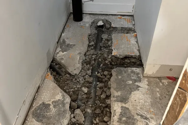 excavating the laundry room to expose the pipes.