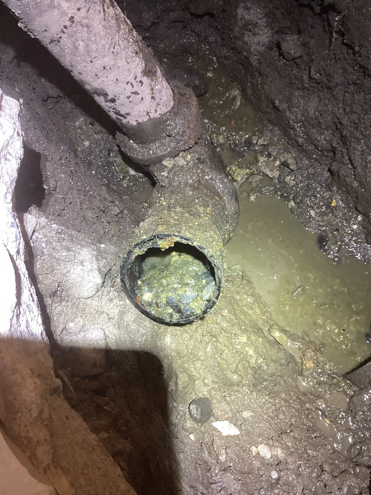 underground drain pipe filled with rocks.