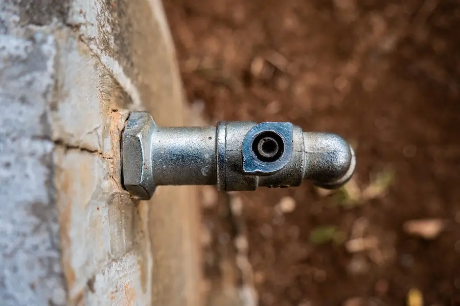 Overhead view of an outdoor faucet with missing handle.