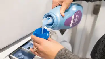 Woman pouring detergent