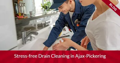 Plumber and customer looking at drain