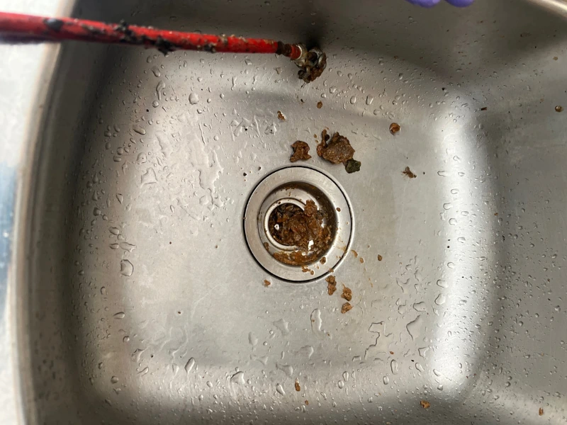 a drain filled with dirt.